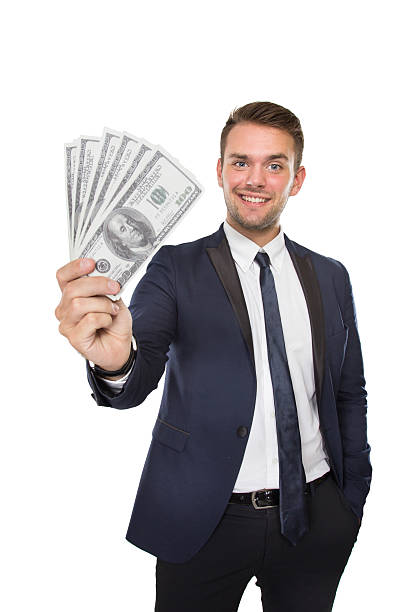 A portrait of a young businessman with dollar on his hands